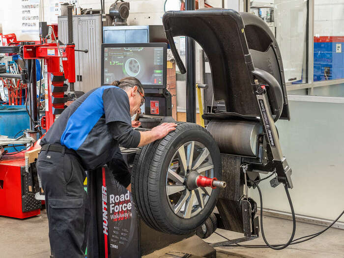 Technician operating the Hunter Road Force wheel balancer