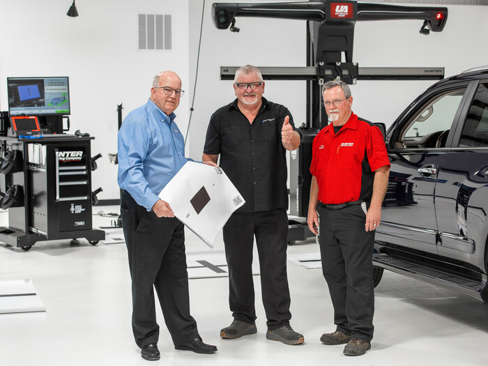 Hunter field team assisting a shop technician with equipment training, showcasing Hunter’s customer support.