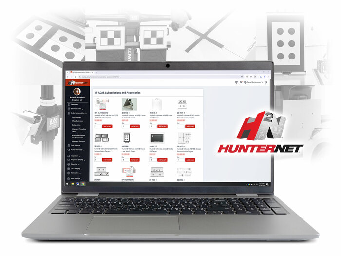 Laptop displaying the HunterNet2 commerce page with calibration targets visible on screen; background features a collage of various target designs.
